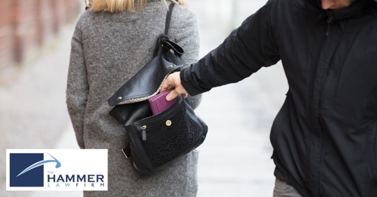 thief stealing from a woman's purse